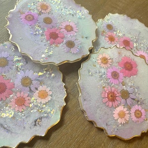 Pastel opal iridescent resin coasters with pink and purple flowers